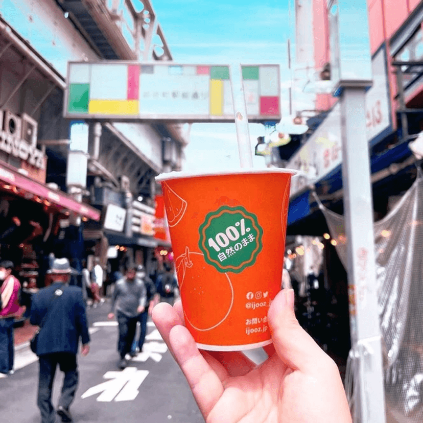 Fresh orange juice being dispensed into a cup